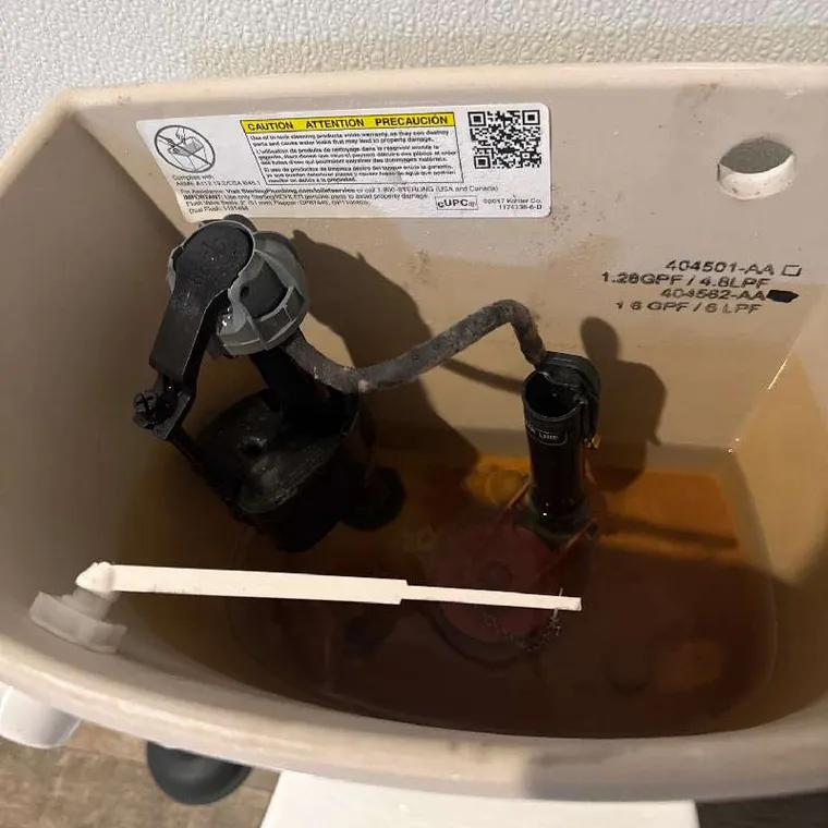 Toilet tank fill valve inspected during low water pressure plumbing service in Muskogee