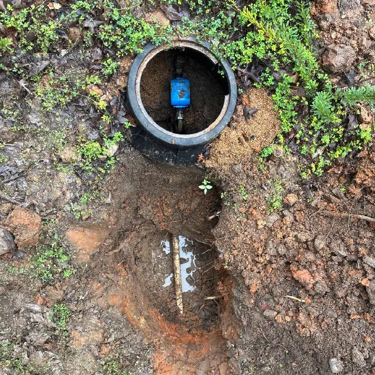 Exposed water line and meter valve during a plumbing repair near Tahlequah