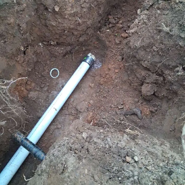 Excavated sewer line trench with new cleanout access during a Clog Hunter sewer line replacement in Tahlequah OK
