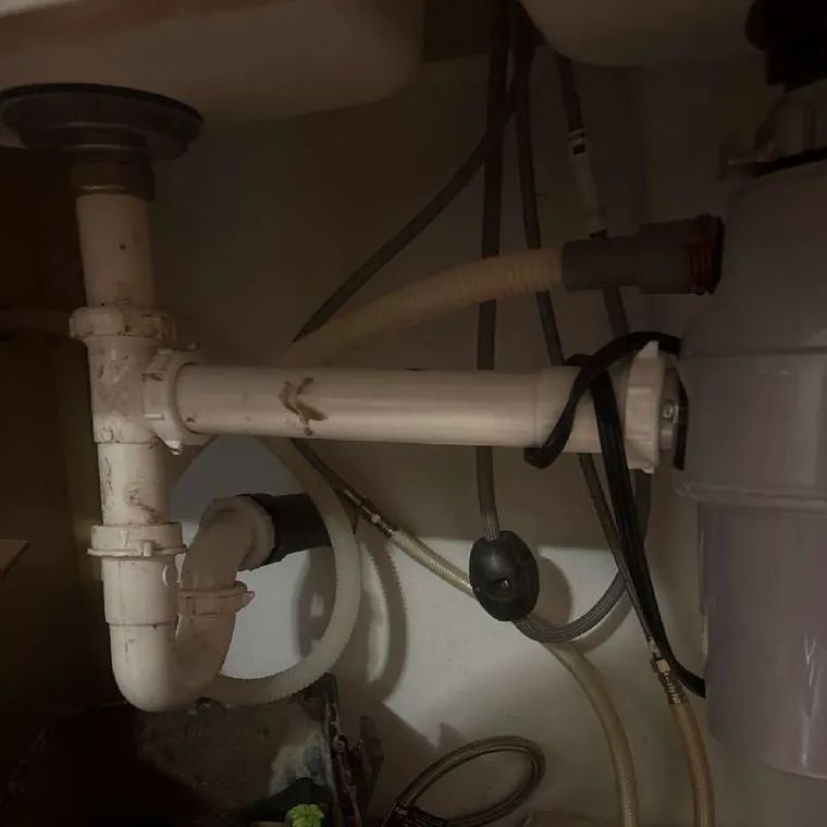 Under-sink plumbing and drain components inspected during a sewer line camera inspection in Tahlequah, OK.