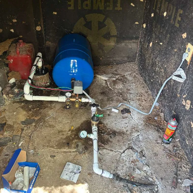 Well pump components and wiring laid out during installation in Stilwell OK property