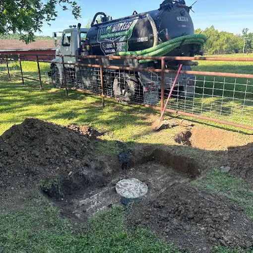Clog Hunter's septic pump truck servicing an exposed tank on a rural Eastern Oklahoma property
