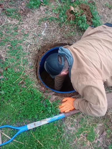 Clog Hunter repairing a septic system component on a rural Eastern Oklahoma property
