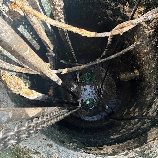 Clog Hunter looking down into a septic tank during service